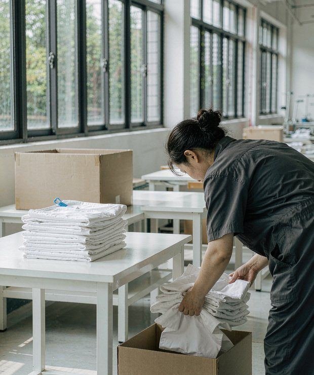 Worker packing finished garments